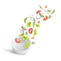 Fresh summer vegetable salad falling in a white porcelain deep plate. Royalty Free Stock Photo
